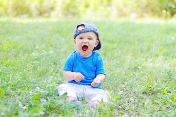 funny baby boy is glad for summer