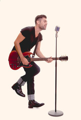 rock star singing with guitar