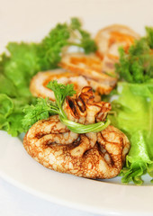 tasty pancakes stuffed with meat served with lettuce and green p