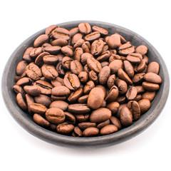 Coffee beans on black saucer.