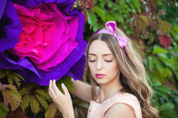 Fototapeta premium Fancy Daydreaming Woman with a huge flower in hands