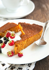 Slices of carrot cake with whipped cream and berry