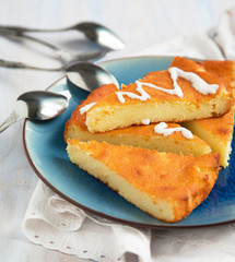 Slices of Baked Ricotta Cake with cream