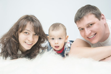 Portrait of Caucasian family with little son together on floor