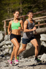 Young sporty couple is doing running exercises - 55610596