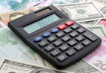 calculating cash: calculator on banknotes