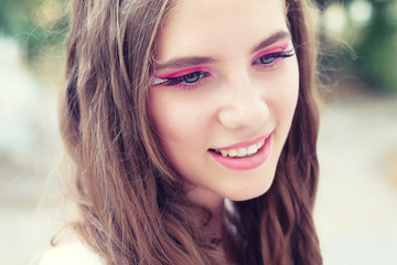 Fototapeta premium beautiful young girl with long hair and makeup for a walk 