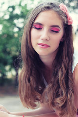 Naklejka premium beautiful young girl with long hair and makeup for a walk 