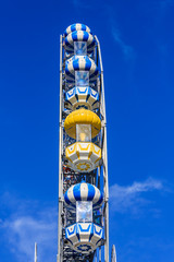 ferry wheel under bright blue sky