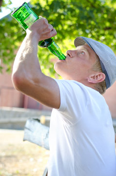 Man gulping alcohol from a bottle
