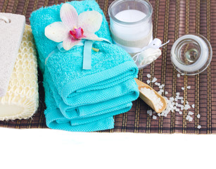 spa settings with blue towels and aroma candle
