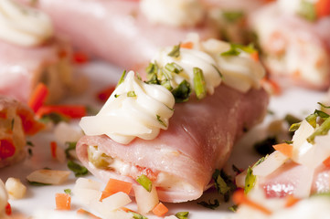 Rolls of ham in aspic with tomatoes
