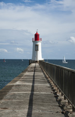 Fototapeta na wymiar Lighthouse at the end of the harbour wall