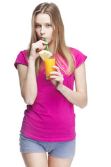 young beautiful blond woman drinking orange juice