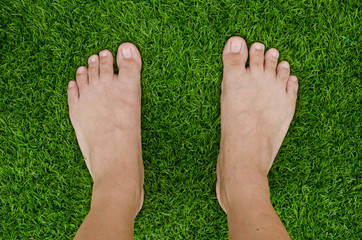 Foot over green grass