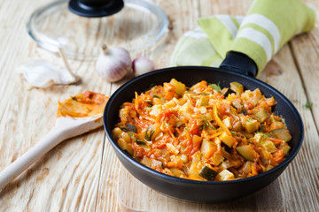 vegetable stew with courgettes in a frying pan