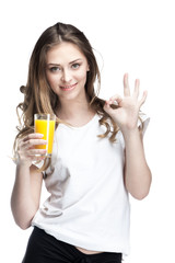 young woman holding glass of orange juice