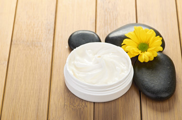 Fototapeta na wymiar cosmetic cream with herbal flower