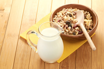 Plate with raw oatmeal on wooden table.