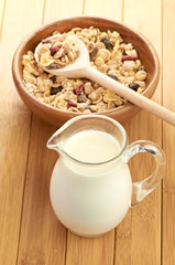Plate with raw oatmeal on wooden table.