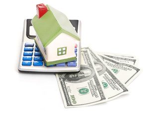 house sitting with a calculator and dollar