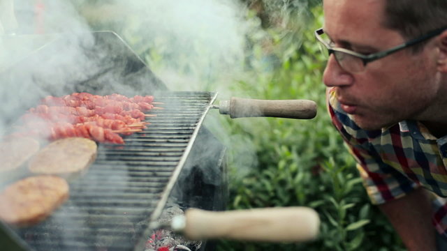 Man burning up grill in the garden