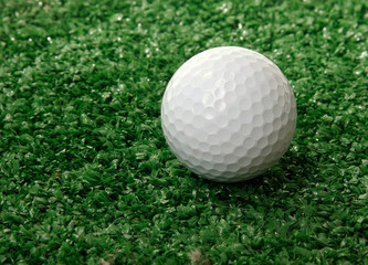 Golf ball ower green grass