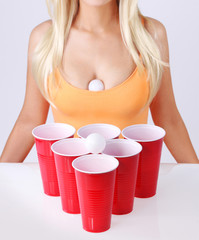Beer pong. Red cups with ping pong ball and sexy blonde girl - 55637340