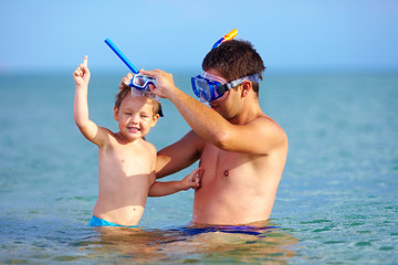 happy father and son snorkeling