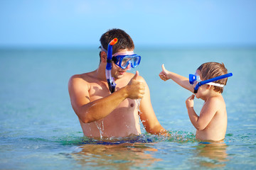 happy father and son snorkeling