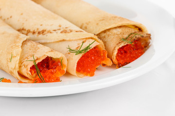 Delicious pancakes with red caviar isolated on white