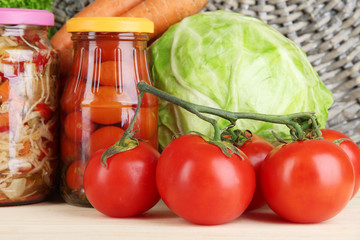 Fresh vegetables and canned on table close up