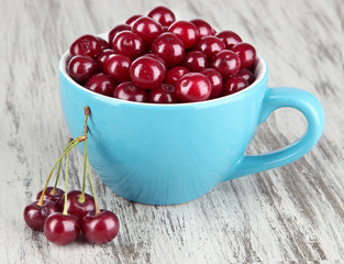 Sweet cherry in cup on table close-up