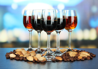 Glasses of liquors with almonds and coffee grains,