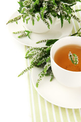 Obraz na płótnie Canvas Cup of herbal tea with fresh mint flowers isolated on white