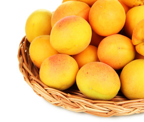 Fresh natural apricot in wicker basket isolated on white