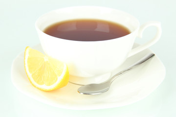 Cup of tea with lemon isolated on white