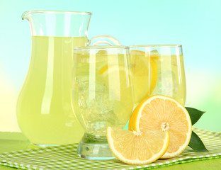 Delicious lemonade on table on light blue background