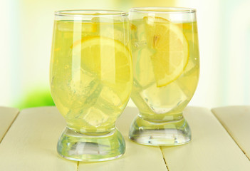 Delicious lemonade on table on light background