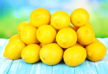 Ripe lemons on table on bright background