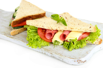 Tasty sandwiches with salami sausage and vegetables