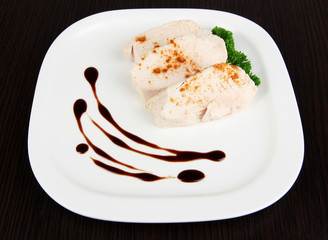 Boiled chicken meat with paprika and sauce, on wooden