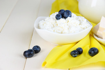 Fresh cottage cheese with blueberry on wooden table close-up