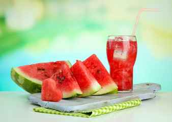 Fresh watermelon and glass of watermelon juice, outdoors