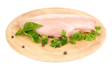 Raw chicken fillets on wooden board, isolated on white