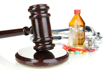 Medicine law concept. Gavel and pills isolated on white