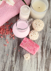 Beautiful spa setting with lily on wooden table close-up