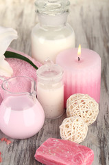 Beautiful spa setting with lily on wooden table close-up