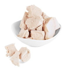 Yeast cubes in bowl isolated on white