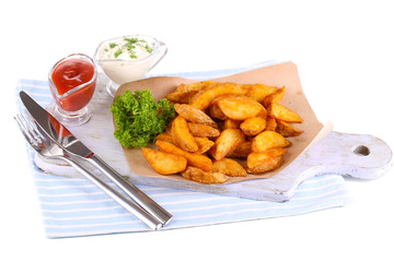 Home potatoes on tracing paper on wooden board isolated on